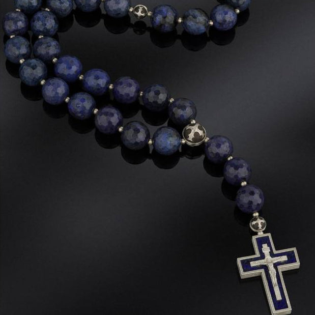 rosary beads with cross pendants on a dark background