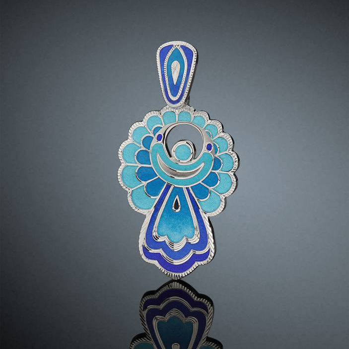 Decorative blue and silver pendant on a dark gray background
