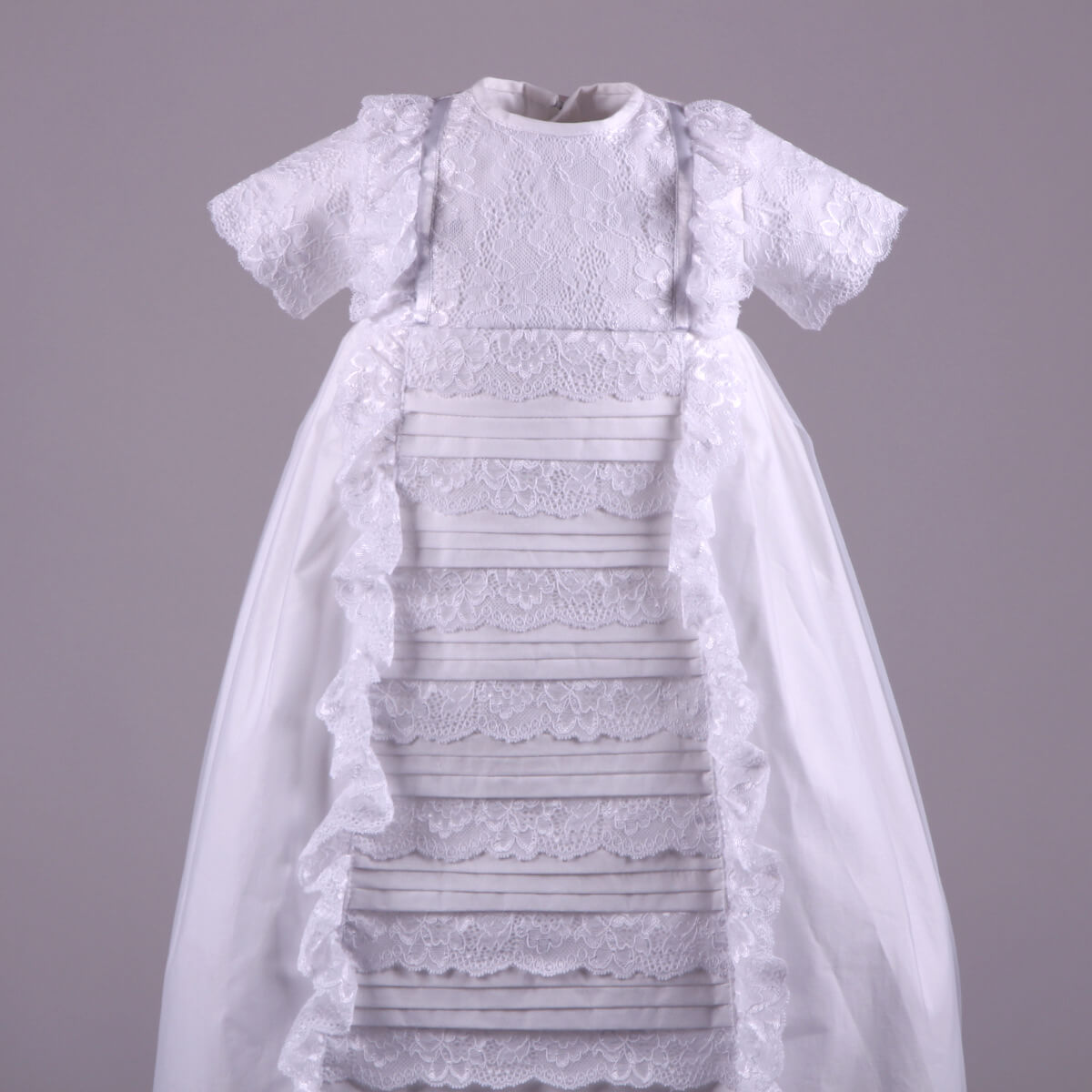 Heirloom Christening Gown with a sheer overlay on a gray background