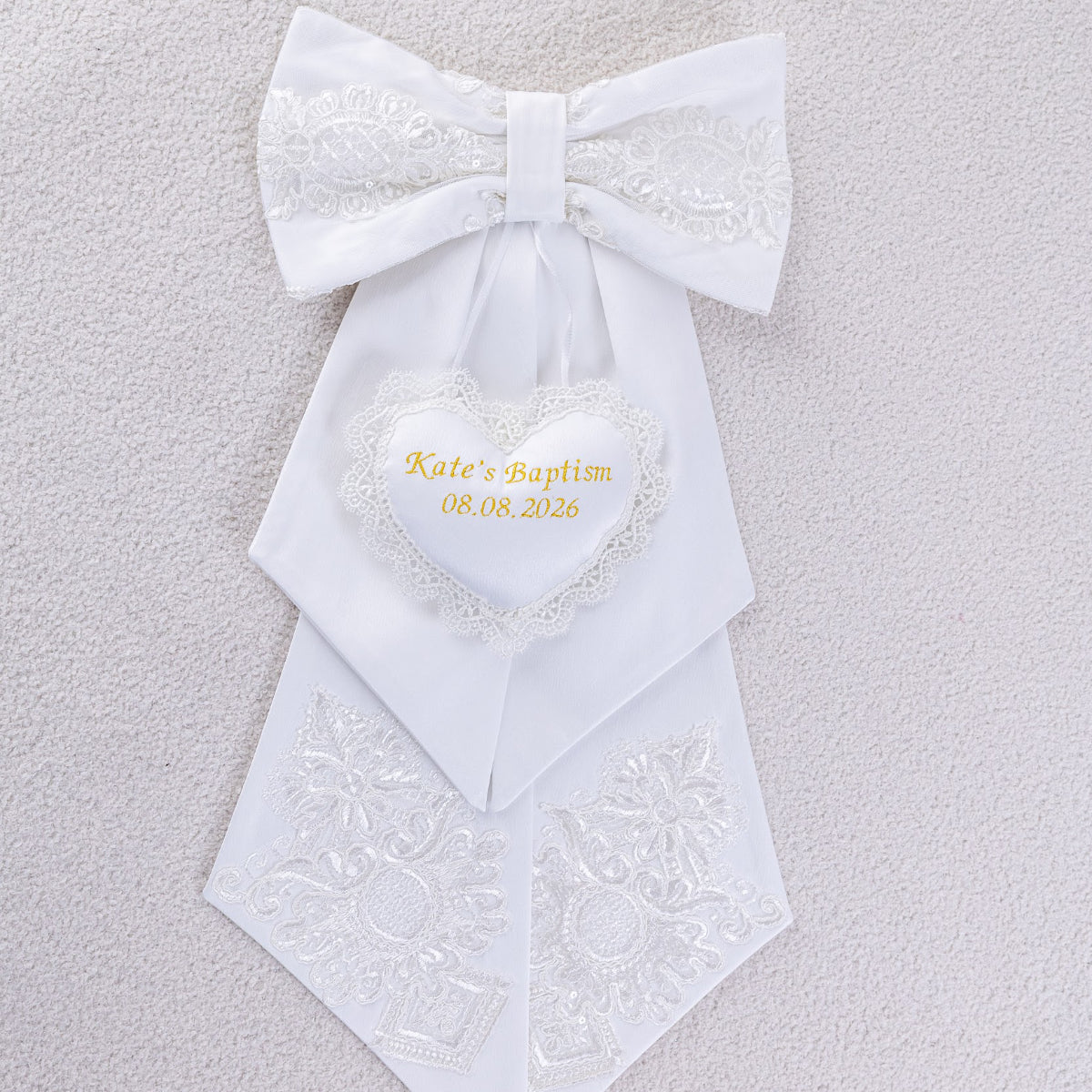Personalized Baptism Keepsake Bow on a textured gray background