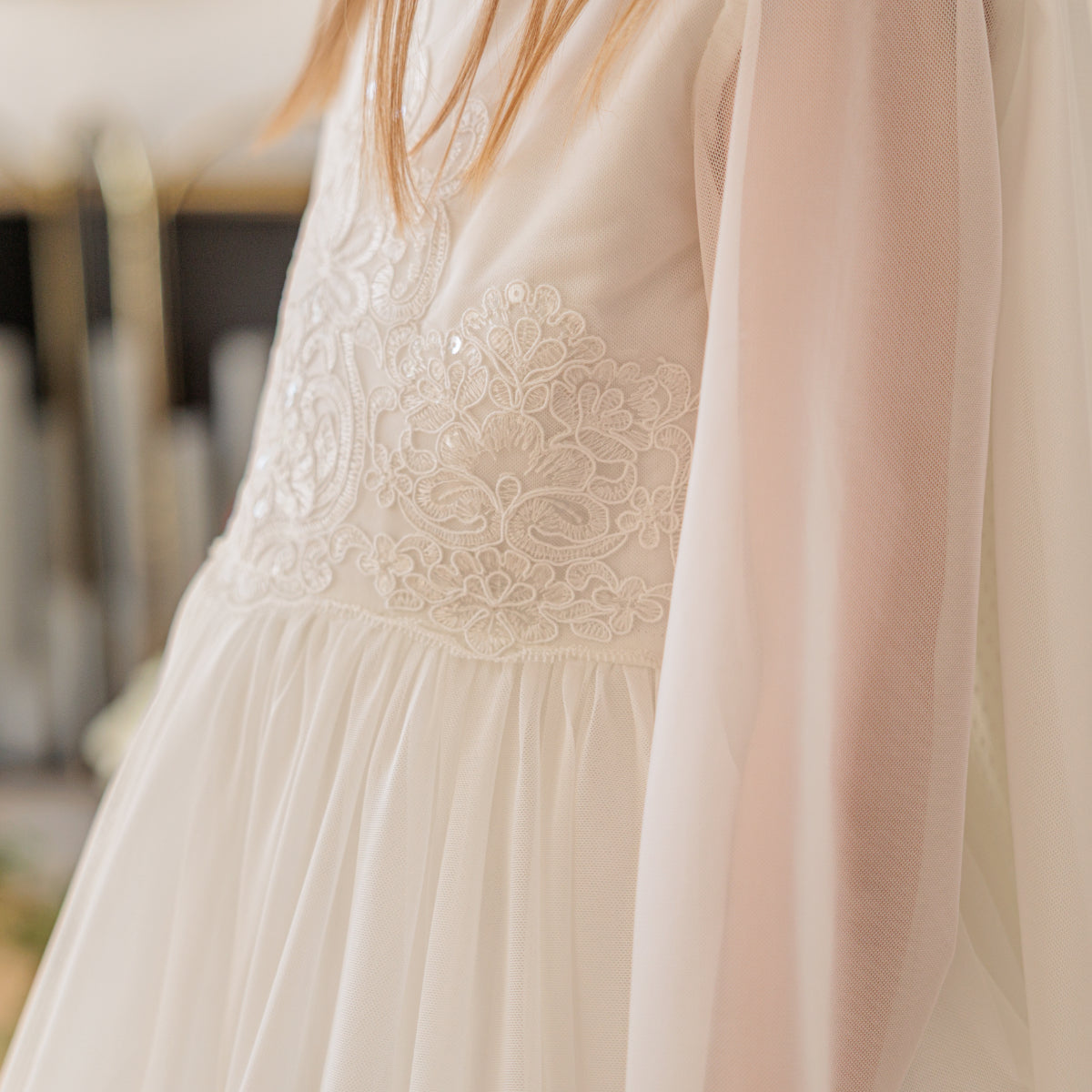 Close-up of a beige dress with lace detailing