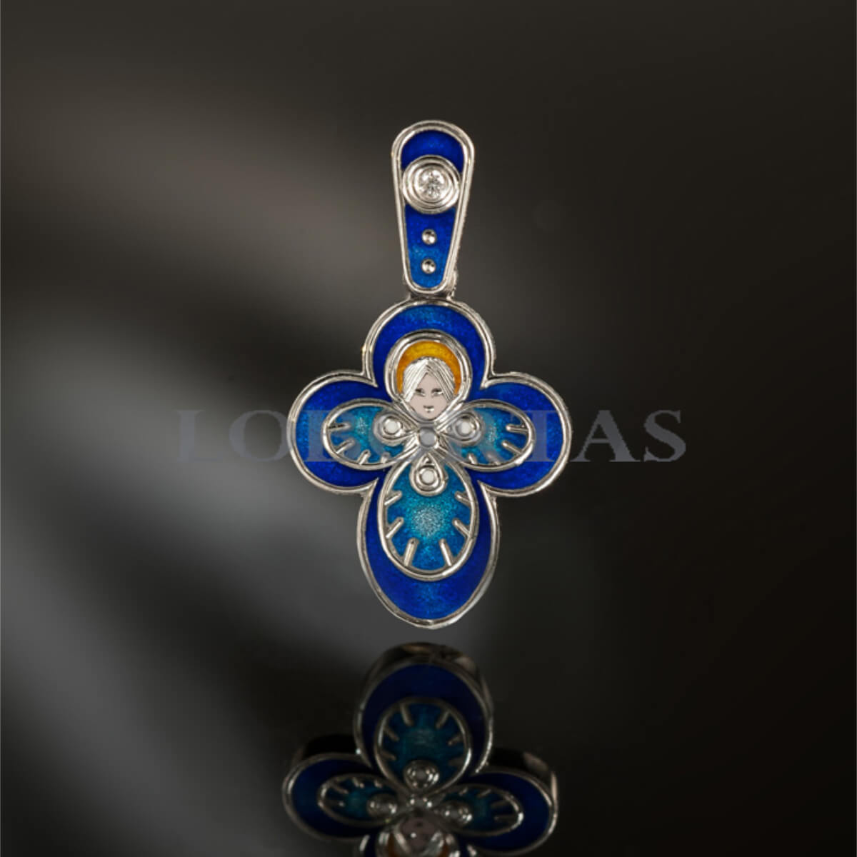 Decorative pendant with blue enamel and silver accents on a dark background