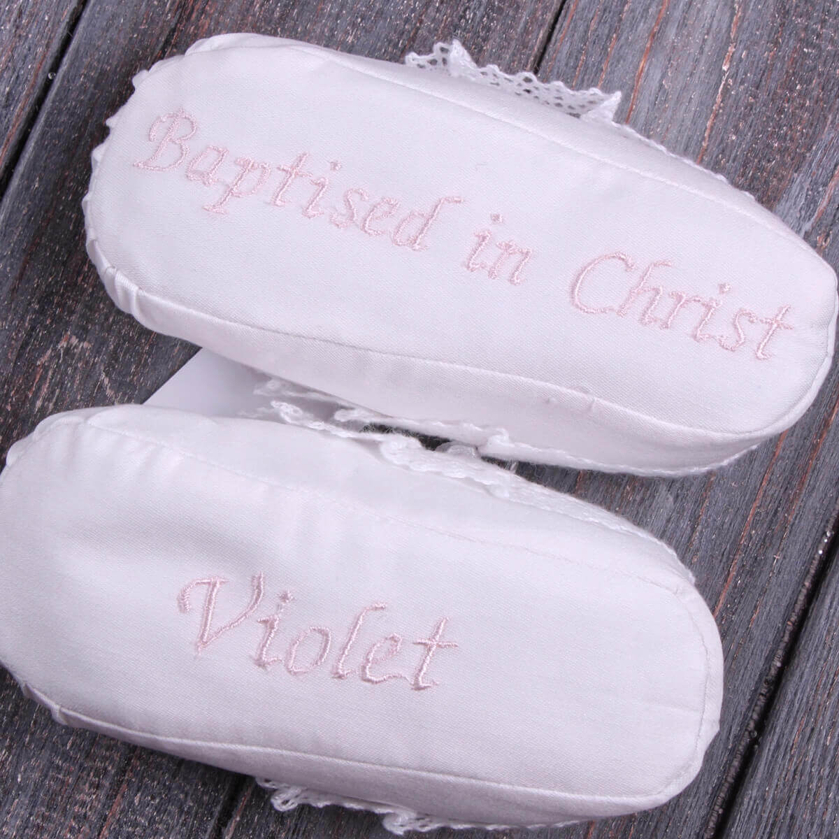 White baby shoes with 'Baptised in Christ' and 'baby name embroidered