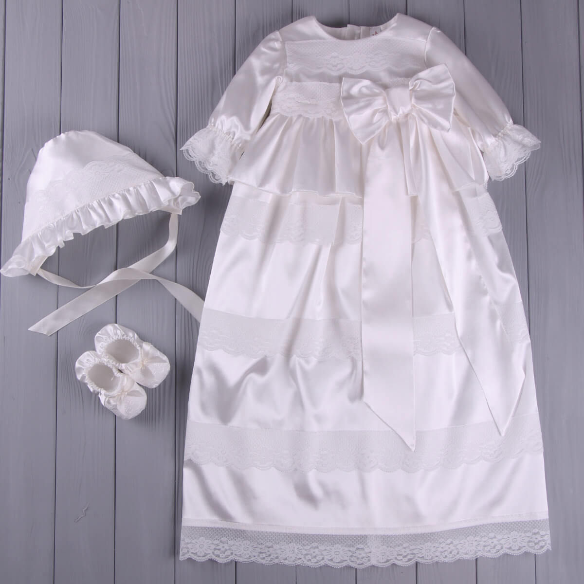 Baptism Gown Set with Hat for Girls – with bonnet and shoes on a wooden surface