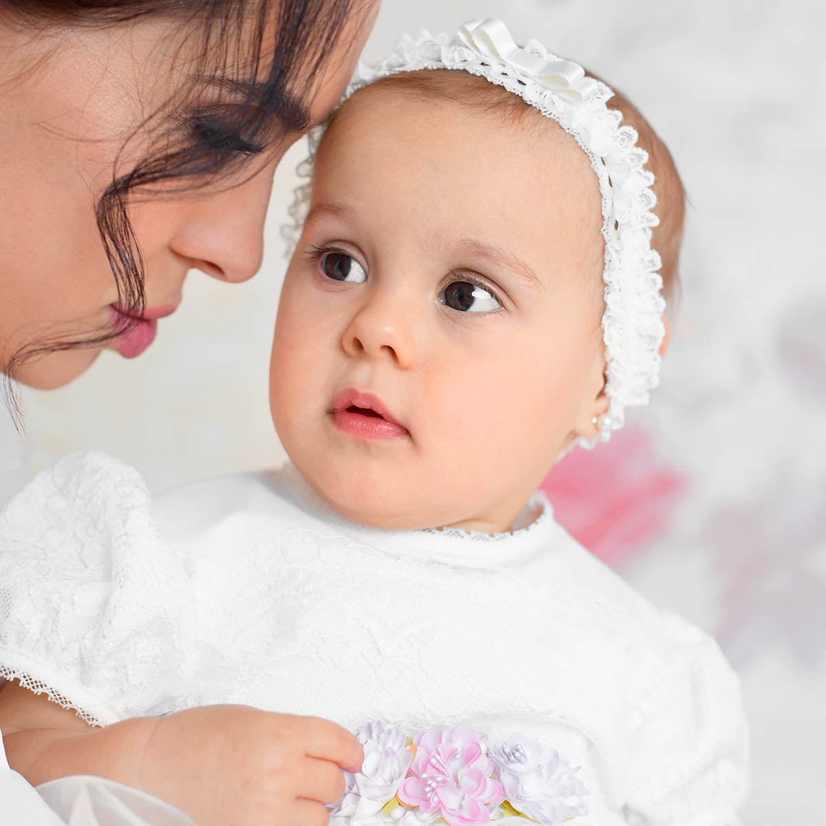 Baby wearing a baby headband for baptism
