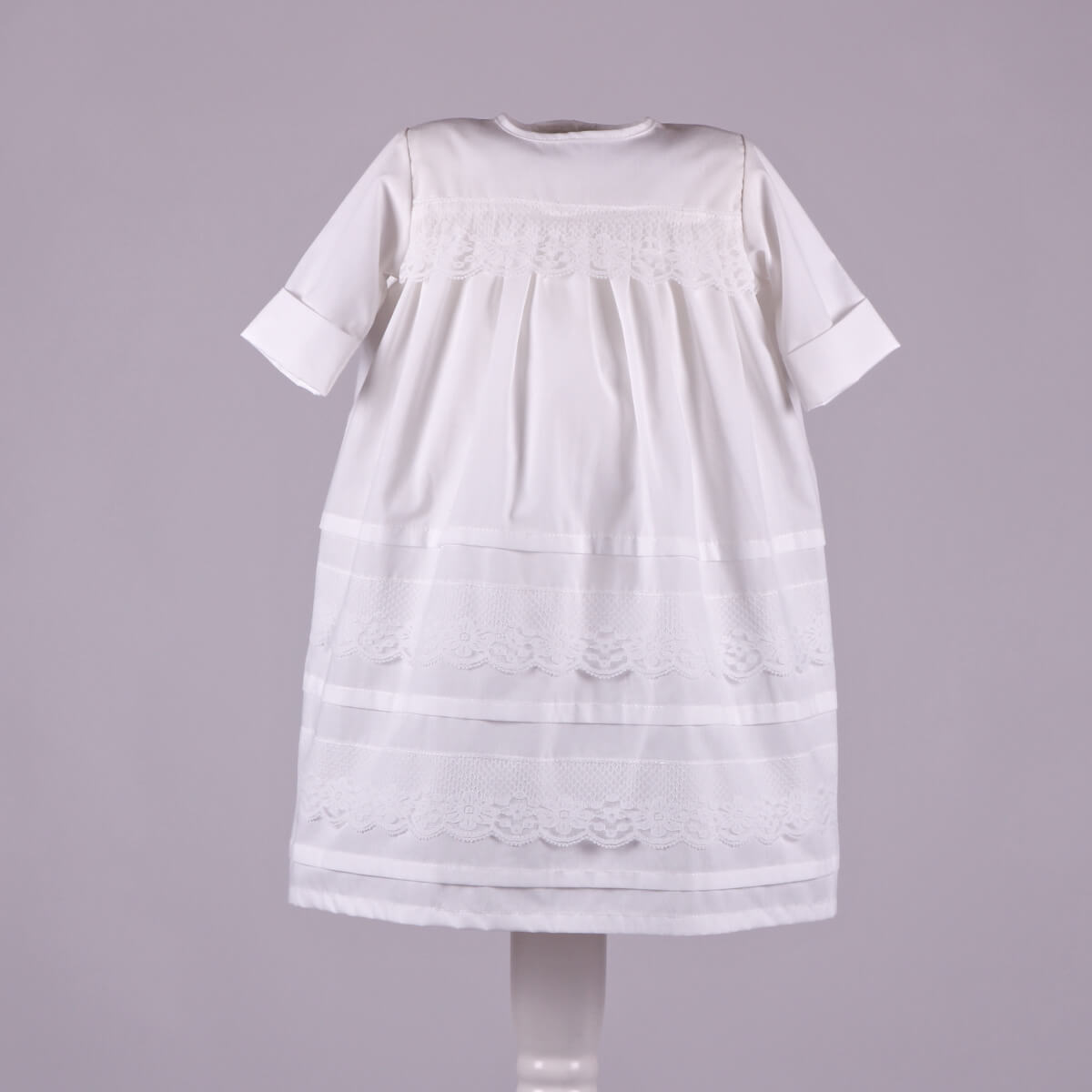 Baptism Outfit Set for Baby Girl with lace details on a gray background