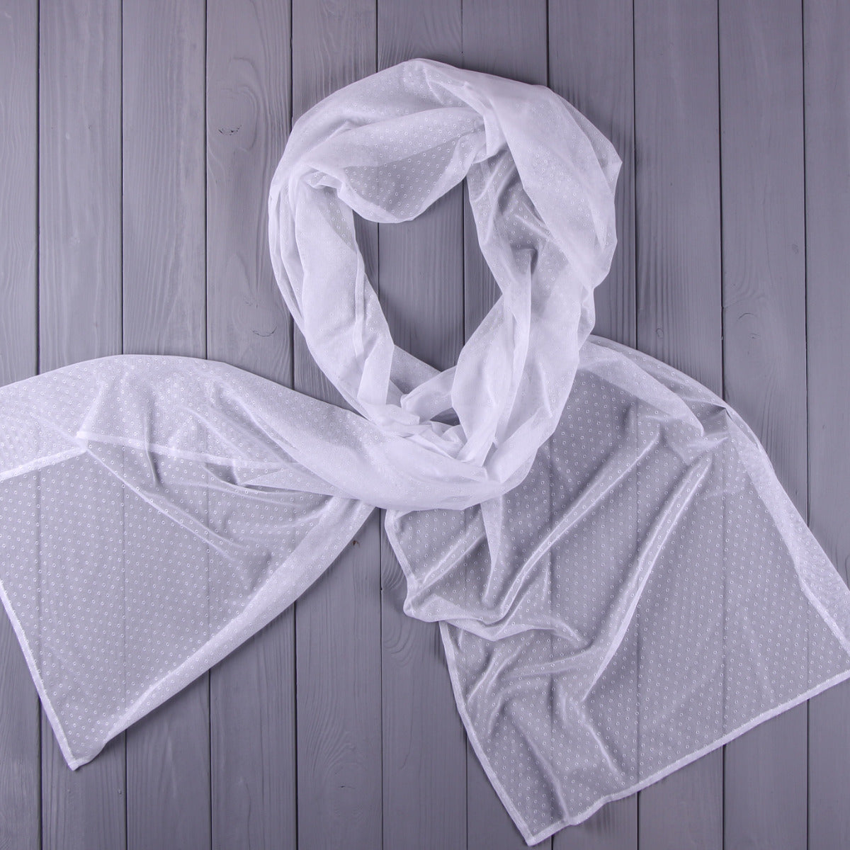 Tulle Chapel Veil f draped over a wooden surface