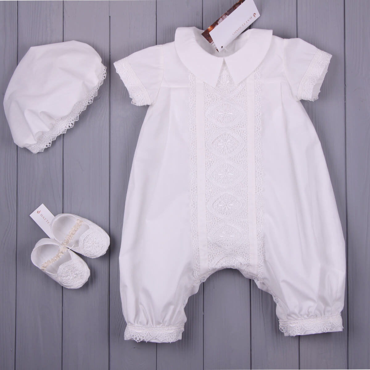 Baby Boy Baptism Romper with bonnet and shoes on a wooden surface