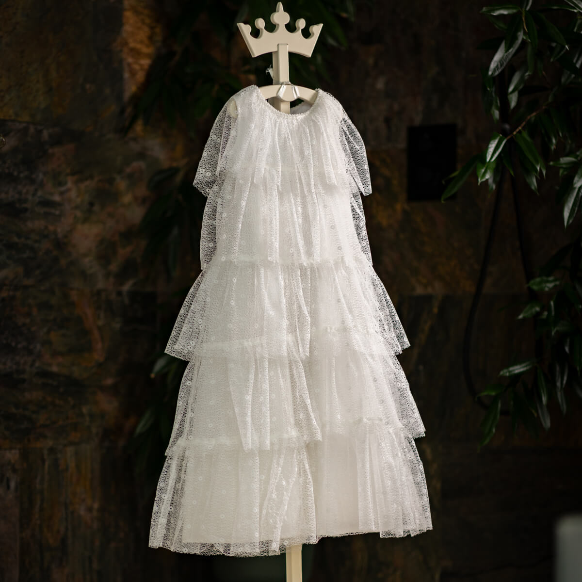 Holy First Communion on a mannequin with a crown against a dark background