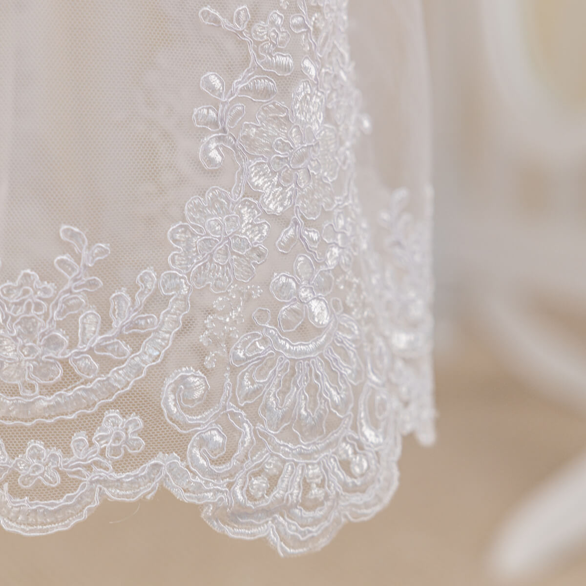 Close-up of i Christening Gown for Girls with floral patterns on a neutral background