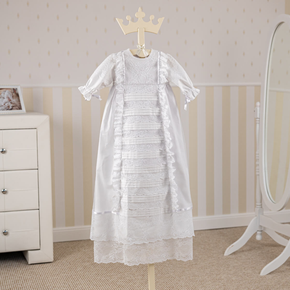 Heirloom Christening Gown on a mannequin with a crown against a neutral background