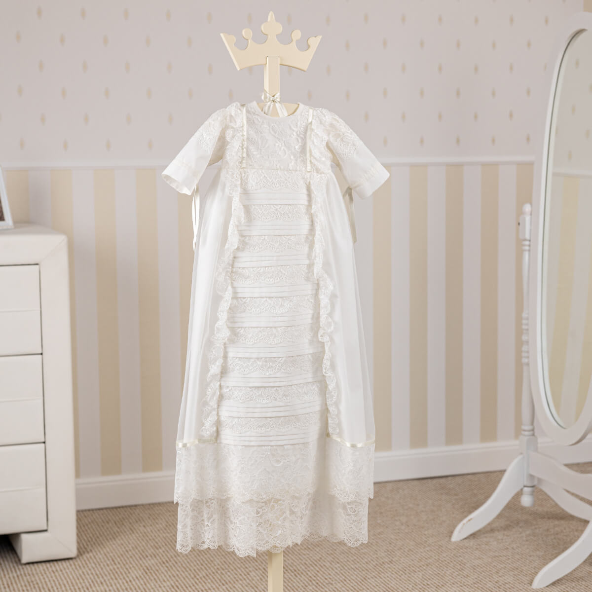 Heirloom Christening Gown on a hanger against a neutral background