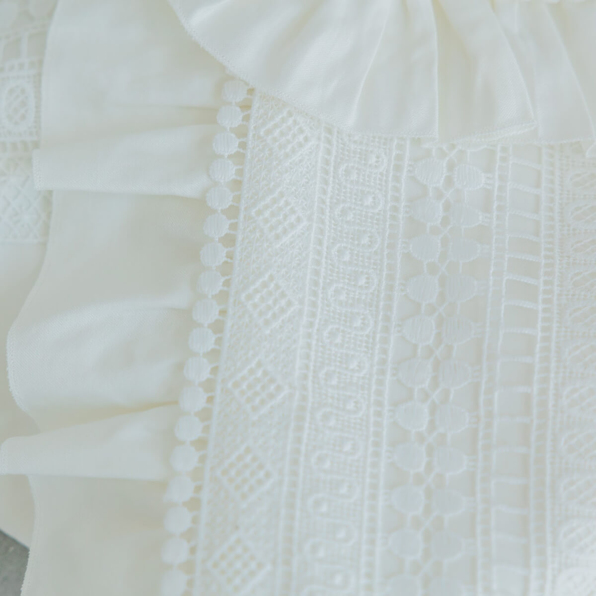 Close-up of a white textured fabric with intricate patterns