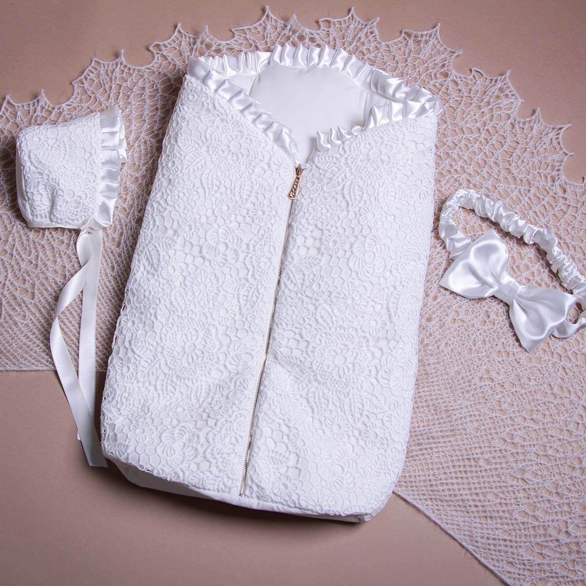 Sleeping sack with hat for summer on a textured surface