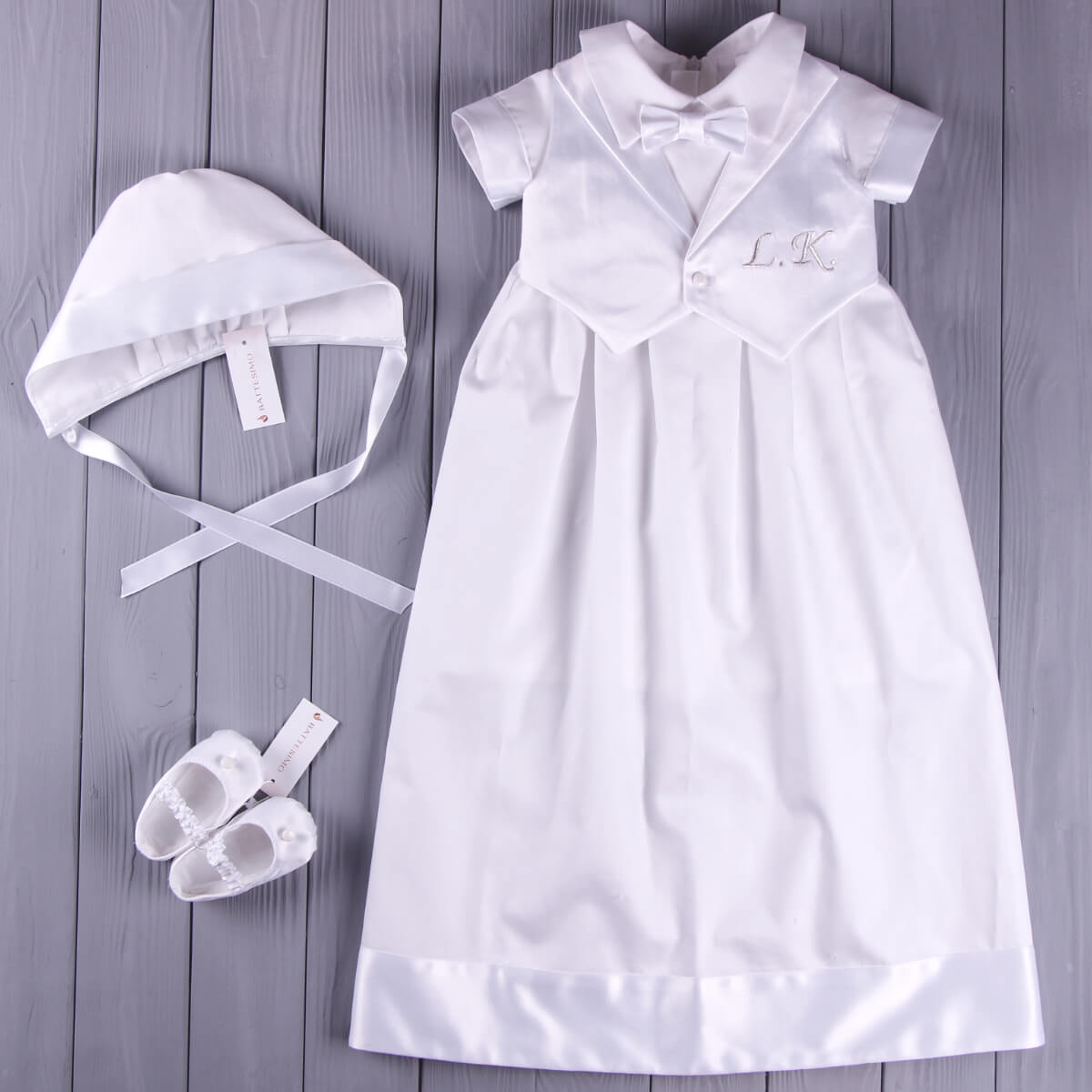 Baptism Outfit for Boys with matching bonnet and shoes on a wooden surface