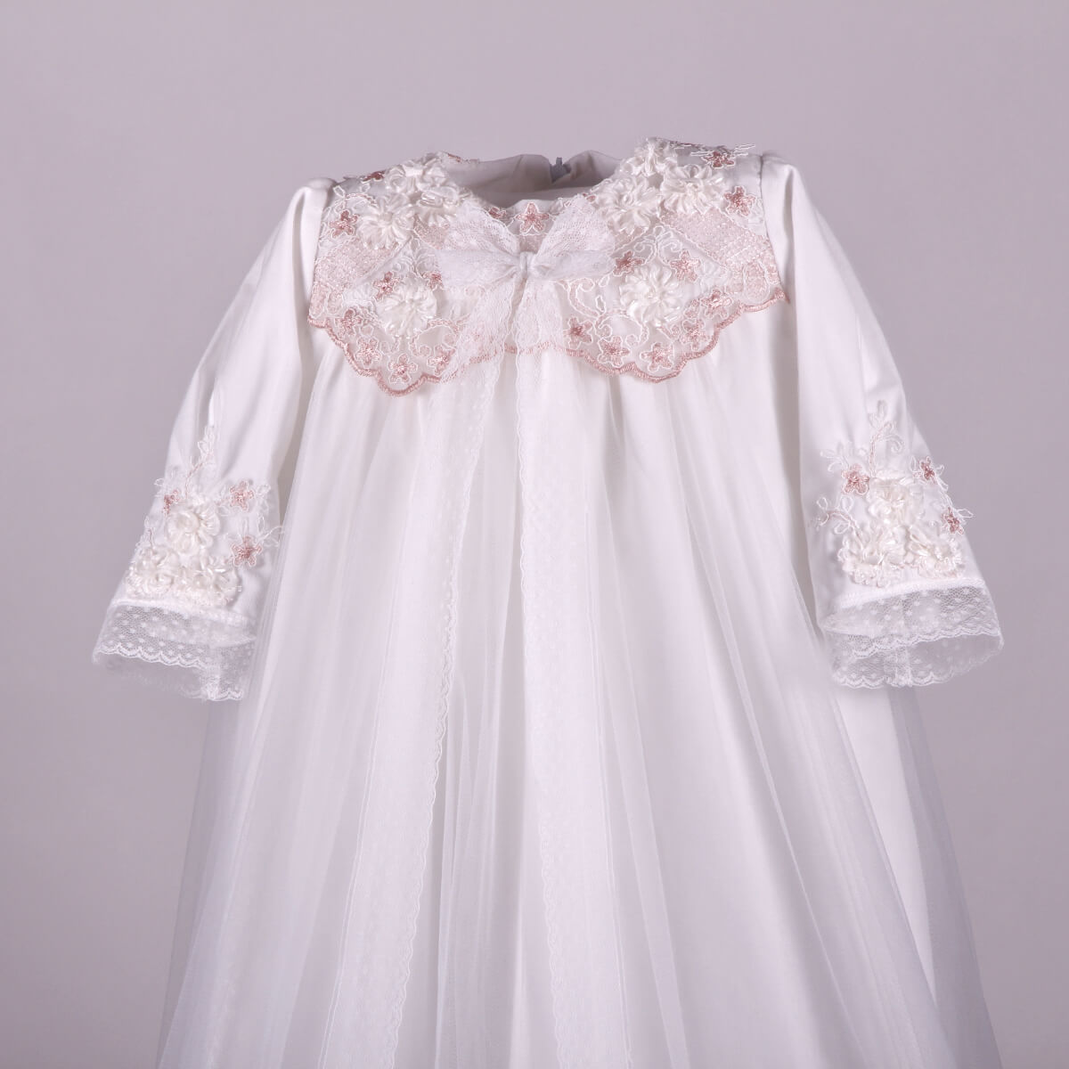Long Christening Gown for Girls with a pink floral collar on a light gray background