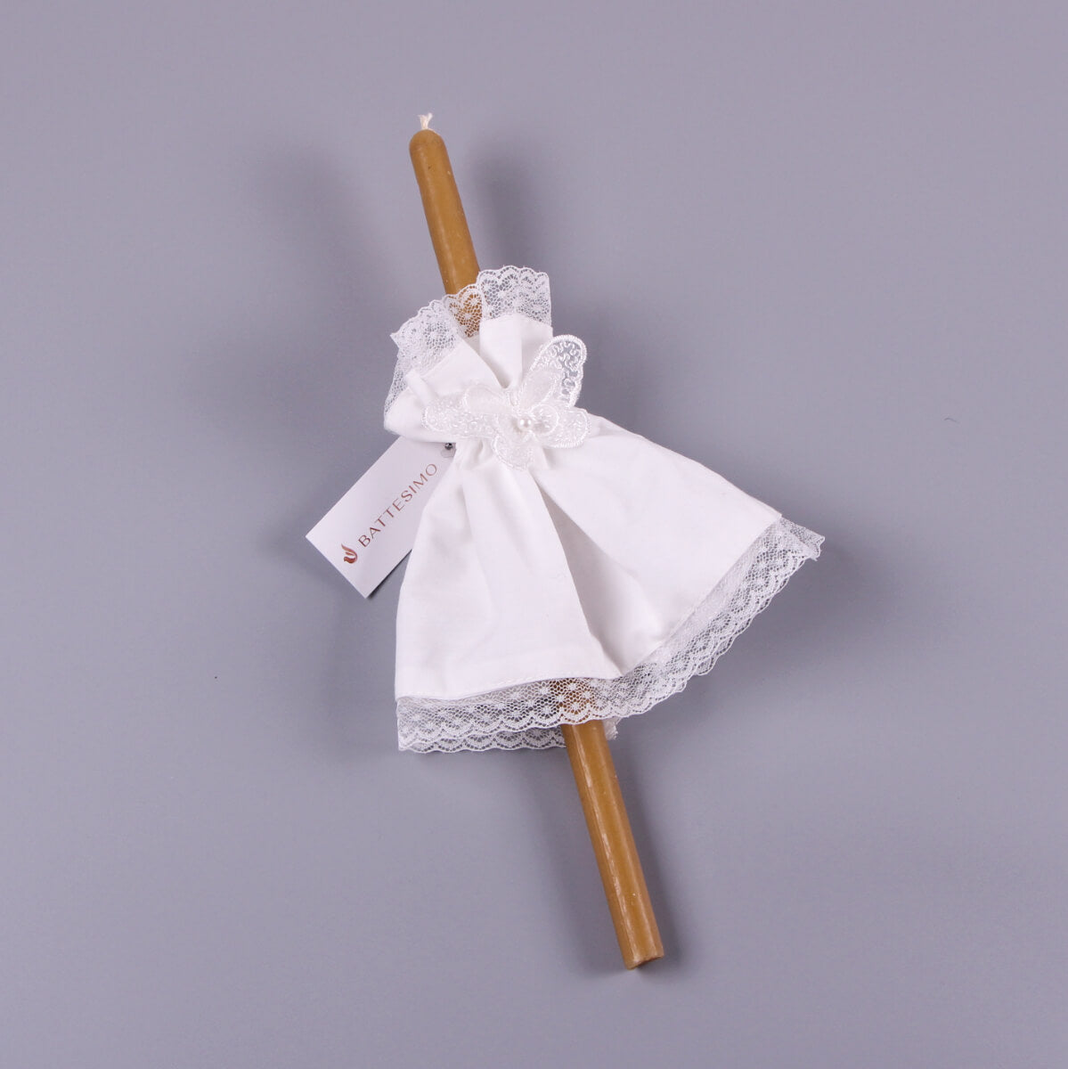 Decorative candle with a Candle Wraps and bow on a gray background