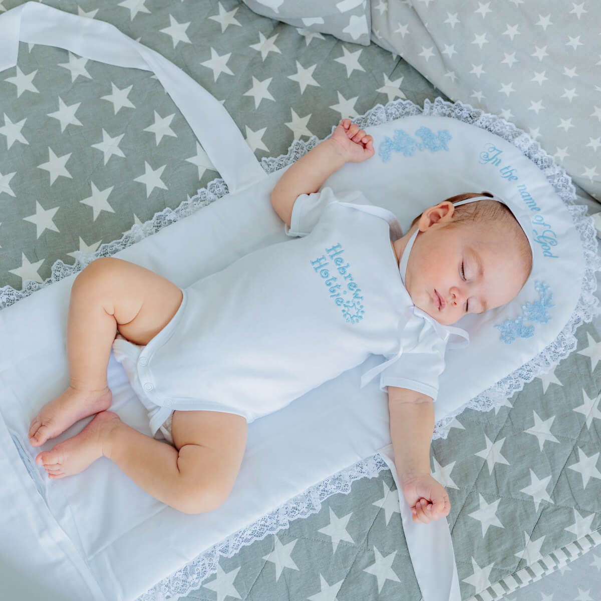 Baby sleeping in a crib with star-patterned bedding