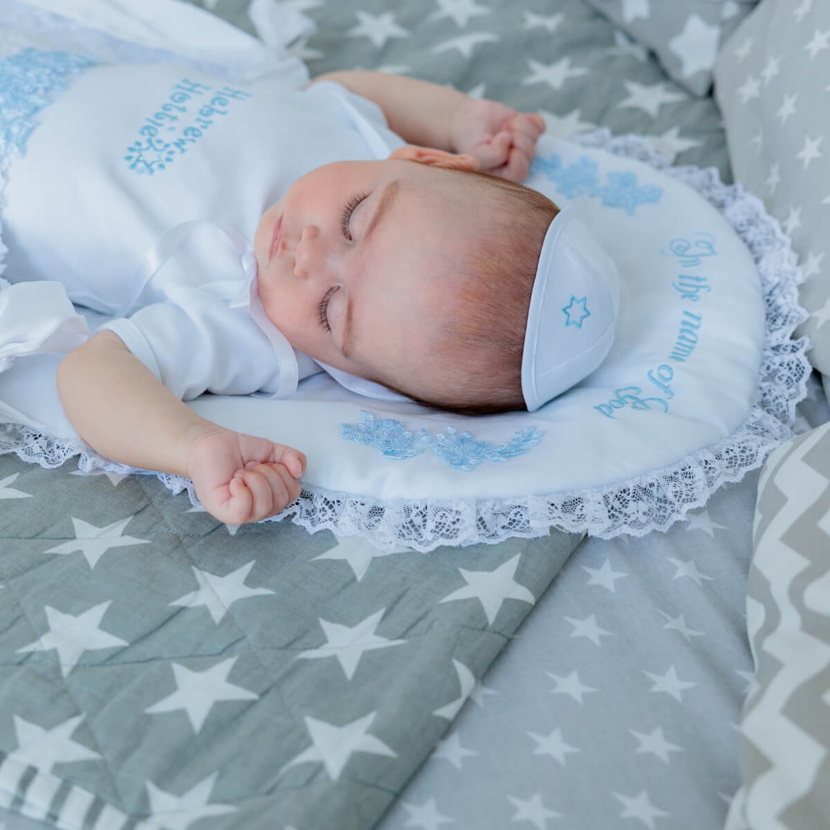 Baby sleeping in a decorative basket with star-patterned bedding