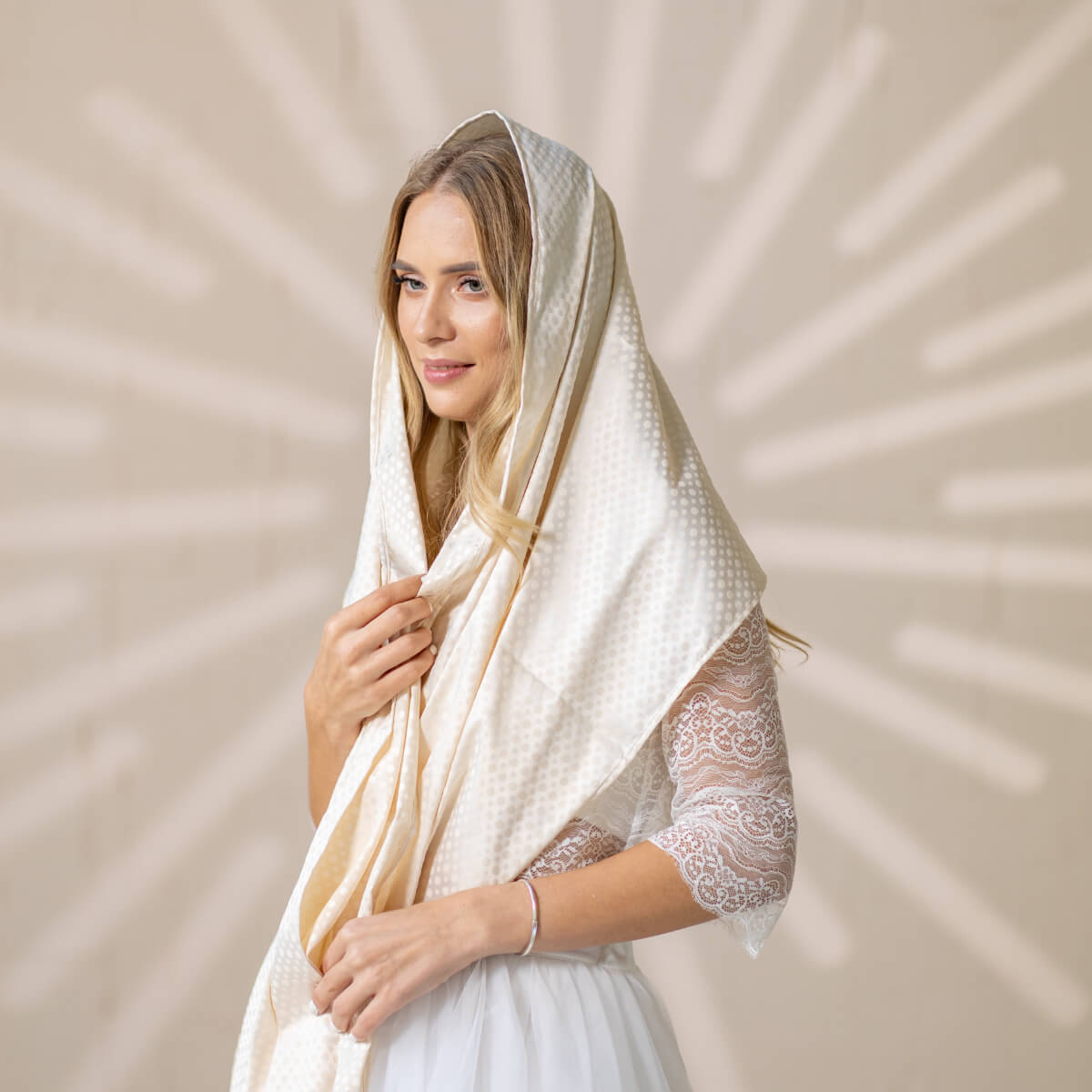 Woman wearing a Silk Chapel Veil against a beige background