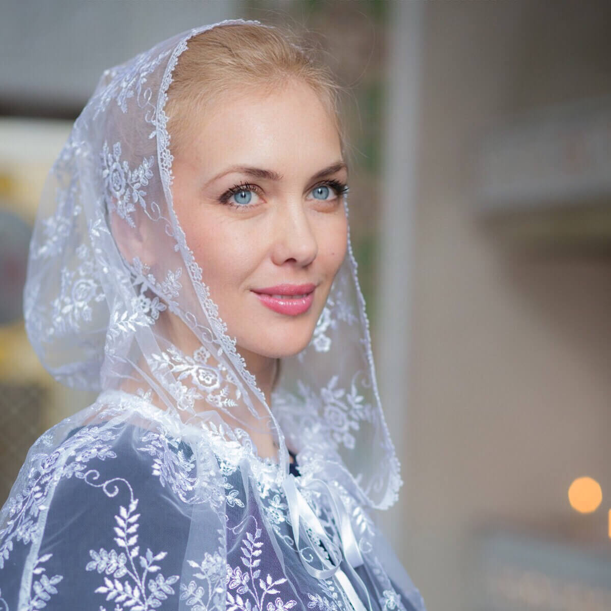 Woman wearing a Hooded Lace Veil with a blurred background