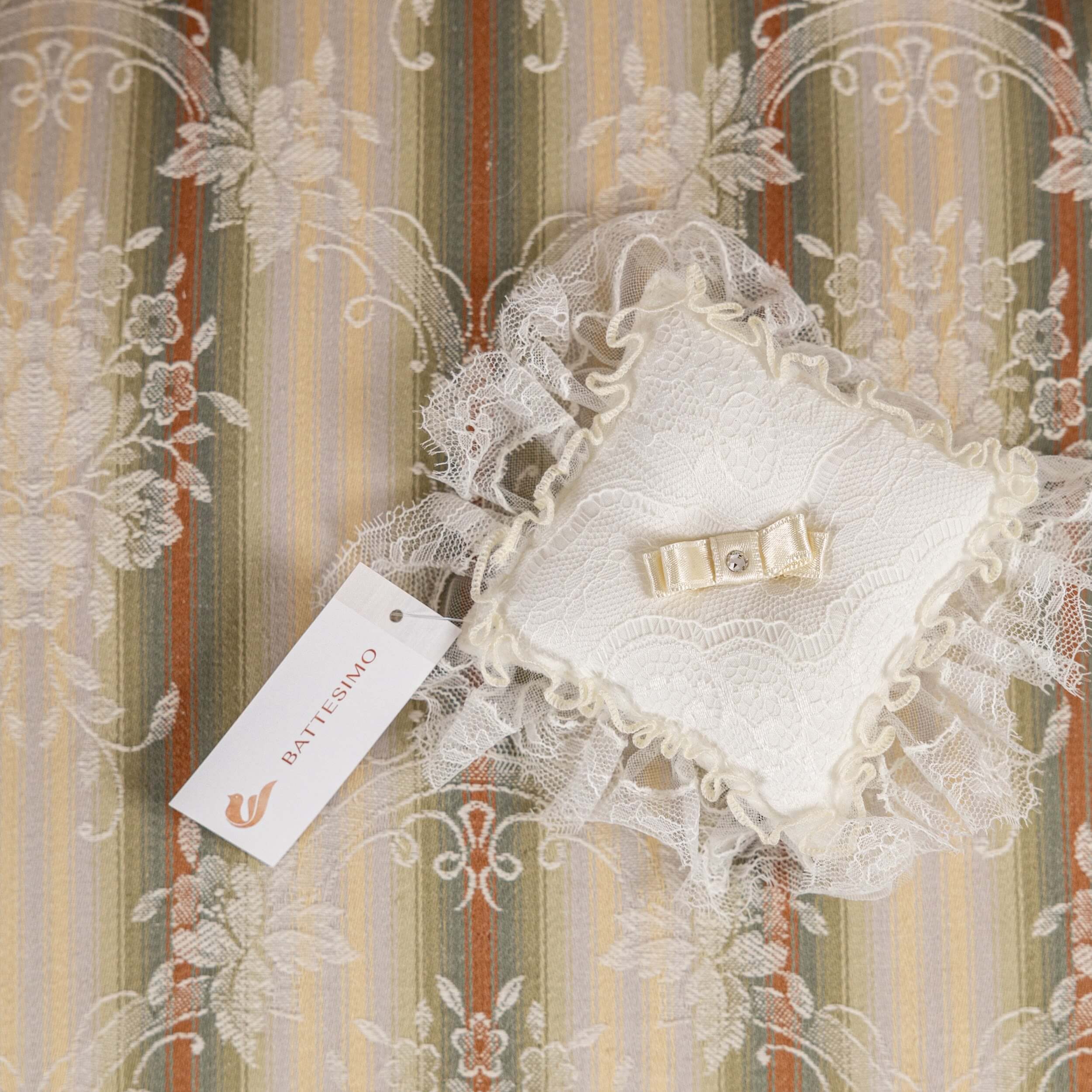 Baptism Ceremony Pillow and Patouani tag on a striped background