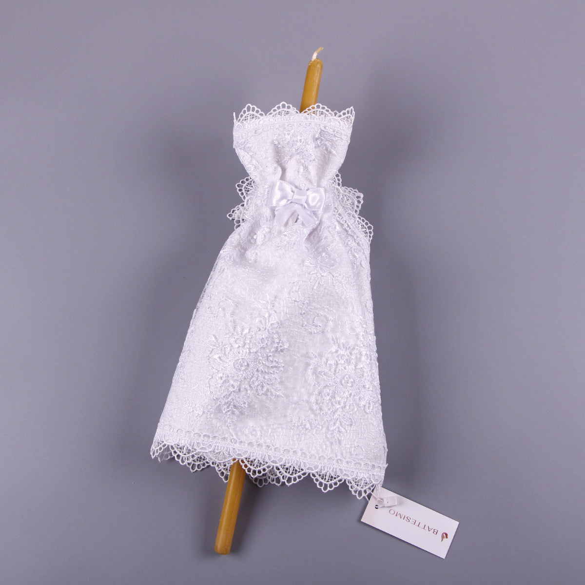 Candle Wraps for Godparents on a wooden stick with a gray background