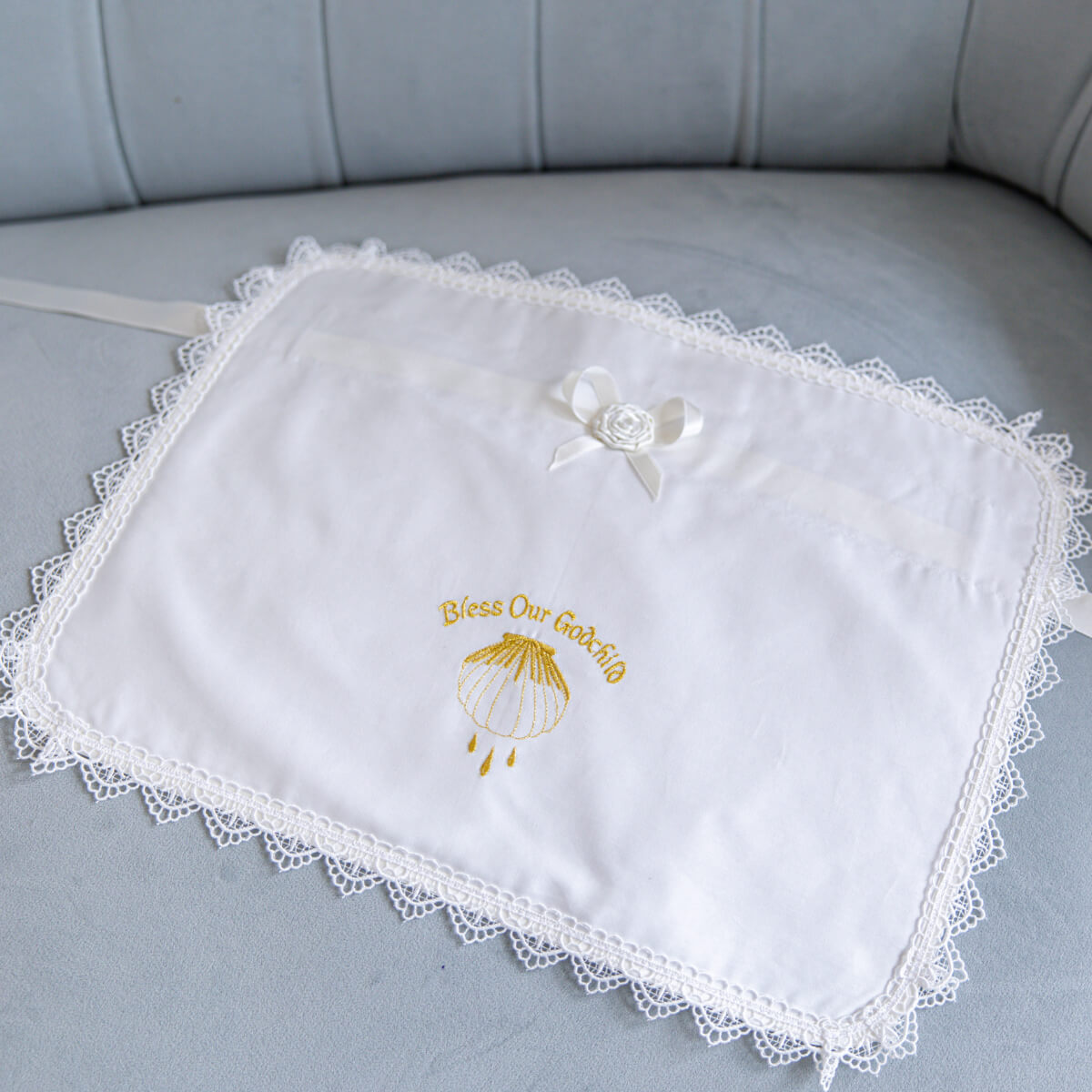 Candle Wraps for Godparentsf with embroidered text and design on a gray surface