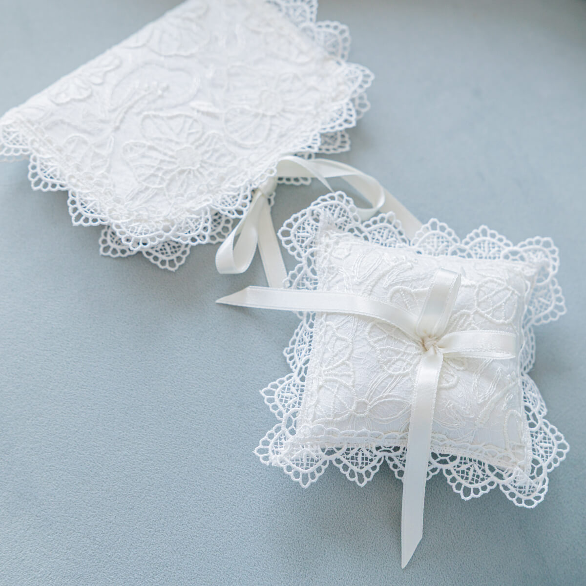 Christening Ceremony Pillow with ribbon on a light blue background