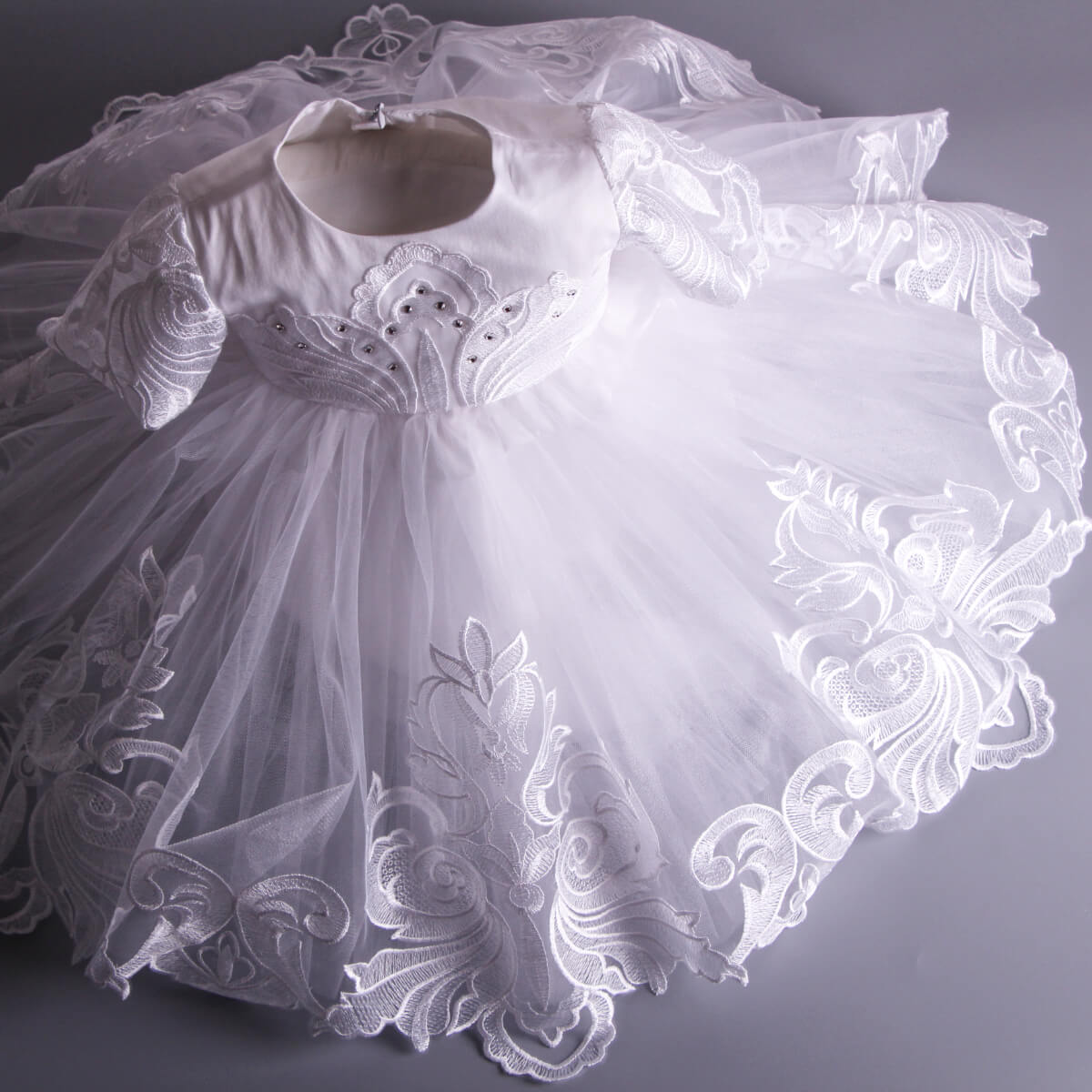 White Baptism Dress on a gray background