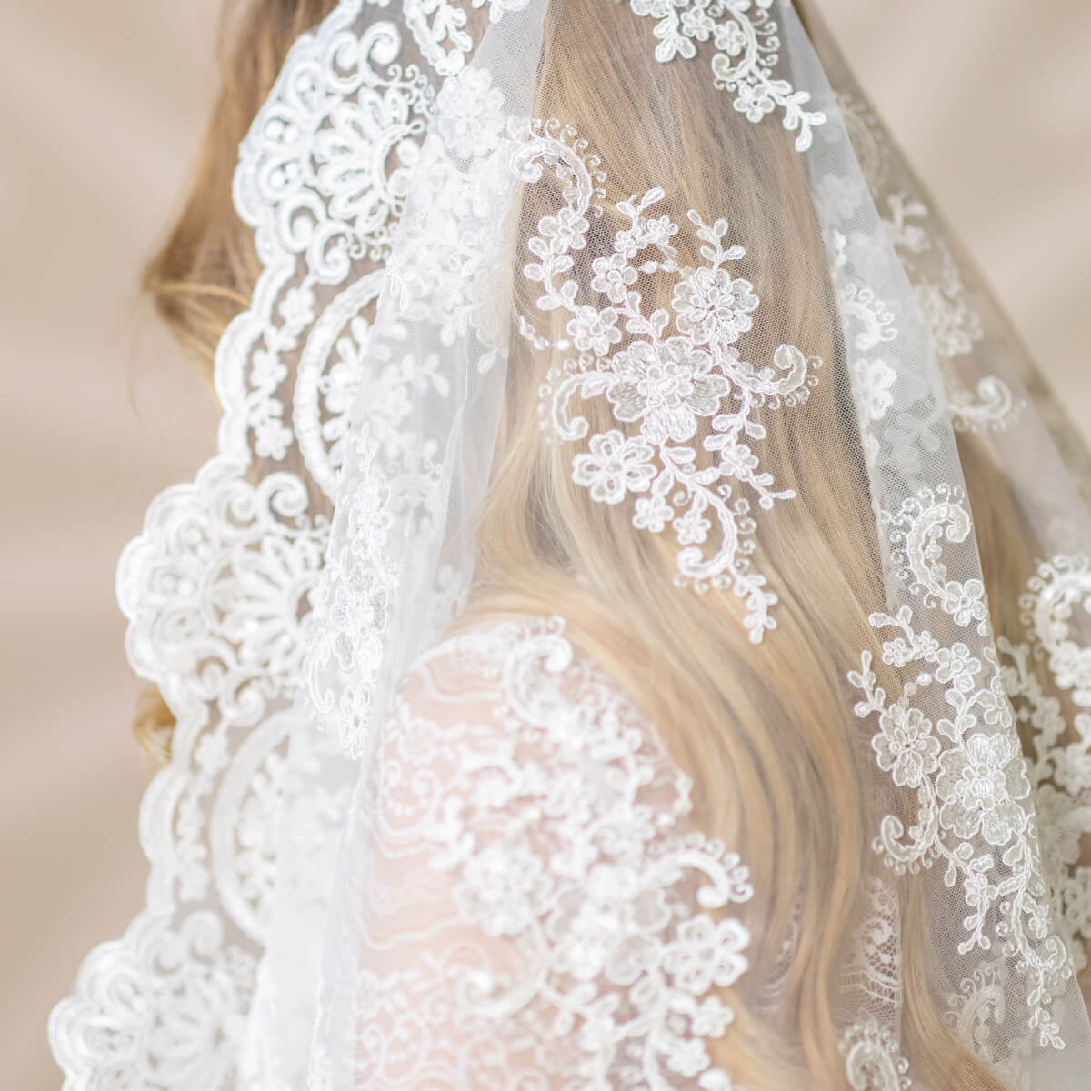 Close-up of a Church Mantilla with intricate designs on a neutral background