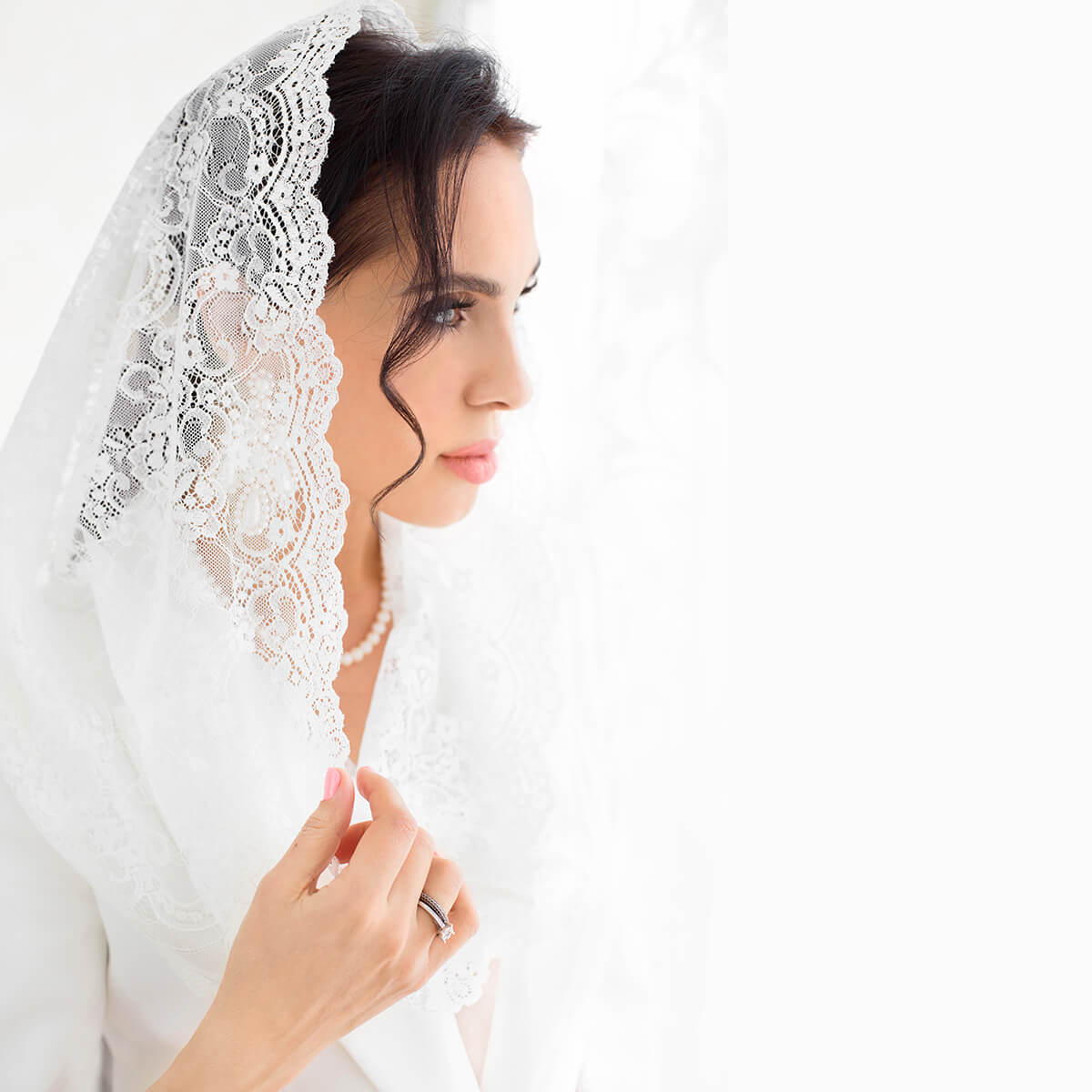 Woman wearing a Catholic Infinity Veil on a white background