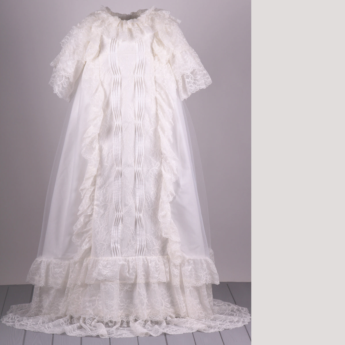Lace christening gown on a gray background