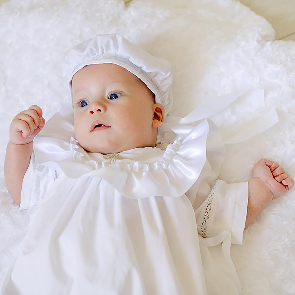 Baby in a Boy Christening Hat lying on a soft surface