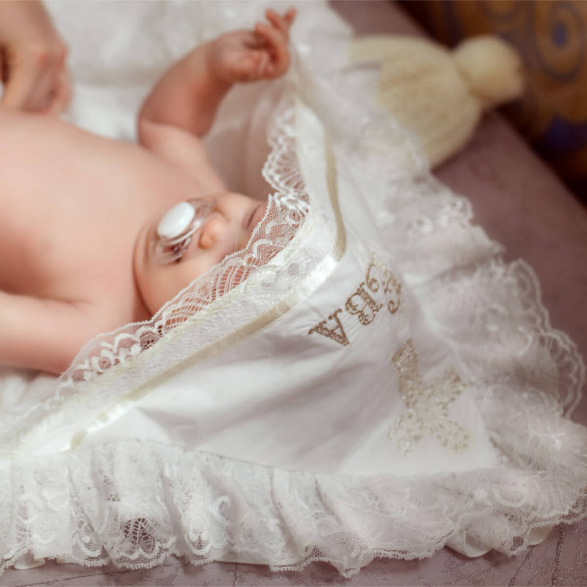 Baby lying on a white lace blanket