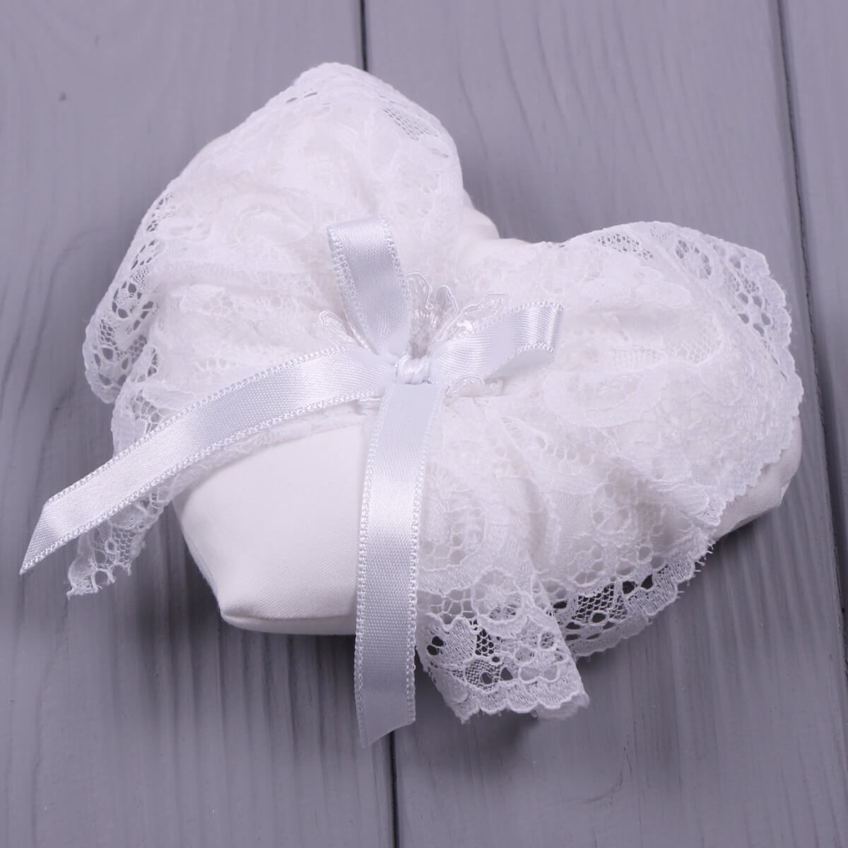 Baptism Ceremony Pillow with ribbons on a gray background