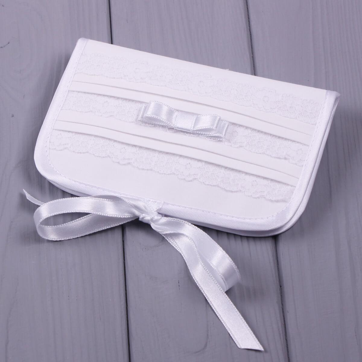 First Curl Keepsake Box for Baptism with a bow on a gray wooden surface