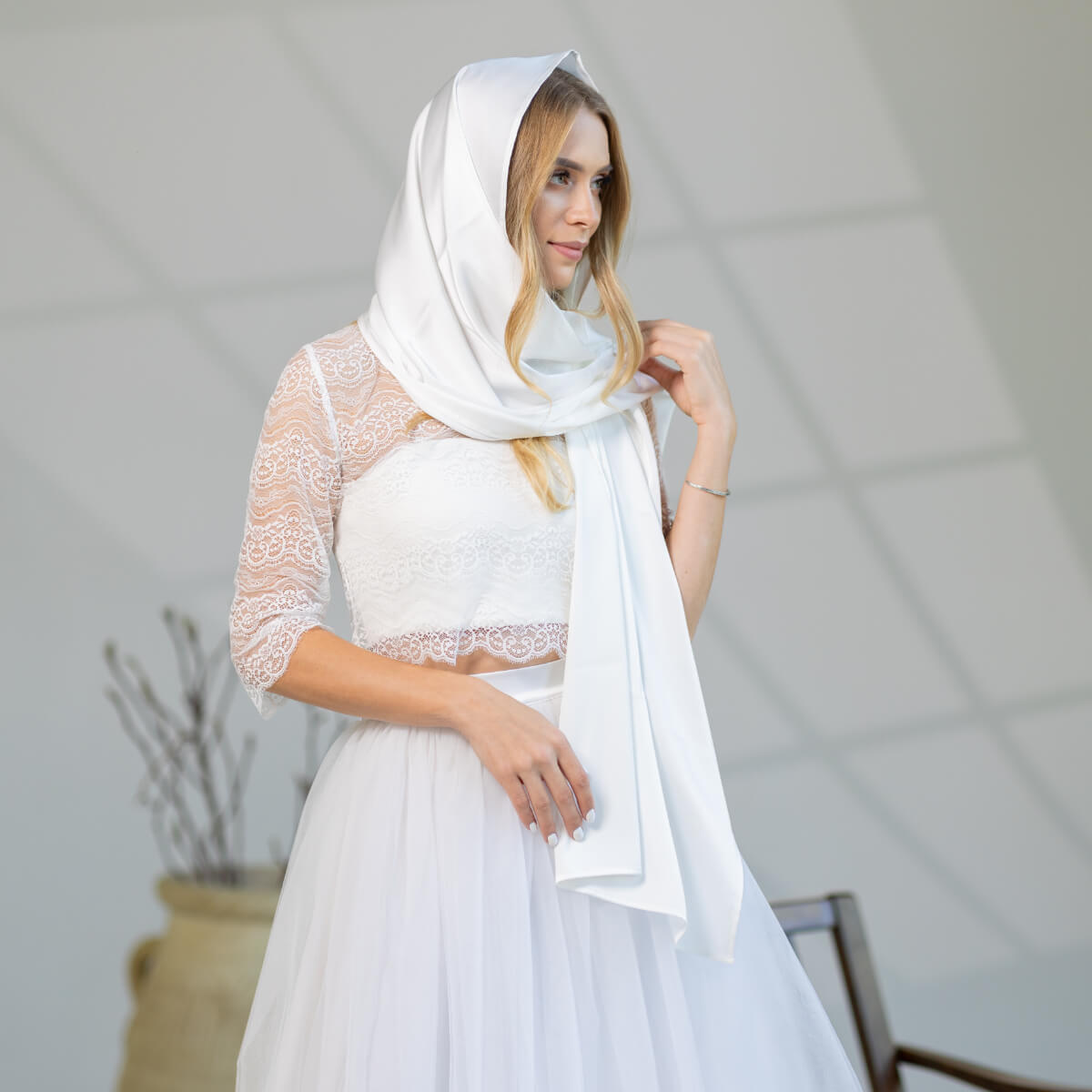 Woman wearing a Church Mantilla and dress in an indoor setting