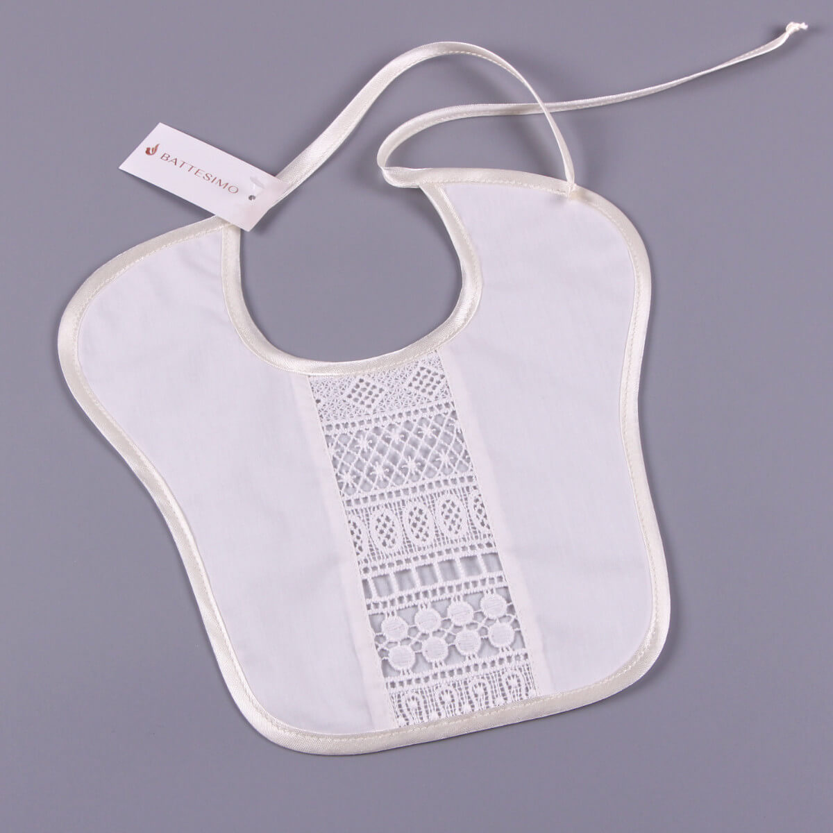 Baptism Bib with a tag on a gray background