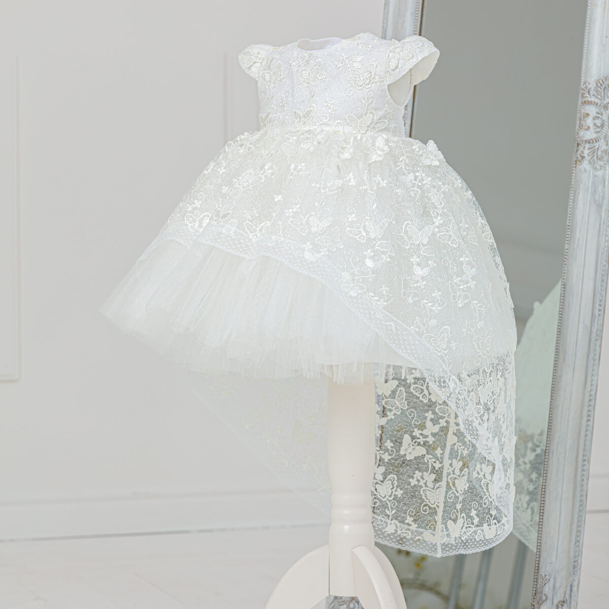 White Baptism Dress with Lace on a mannequin against a neutral background