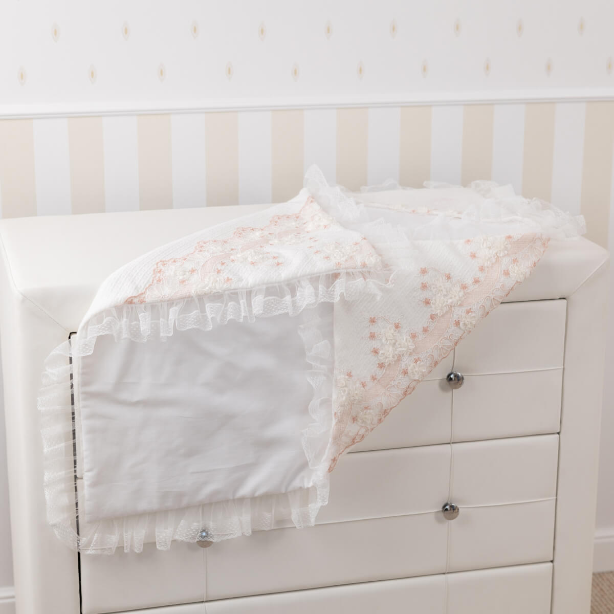Baptism blanket for newborn on a striped wall background