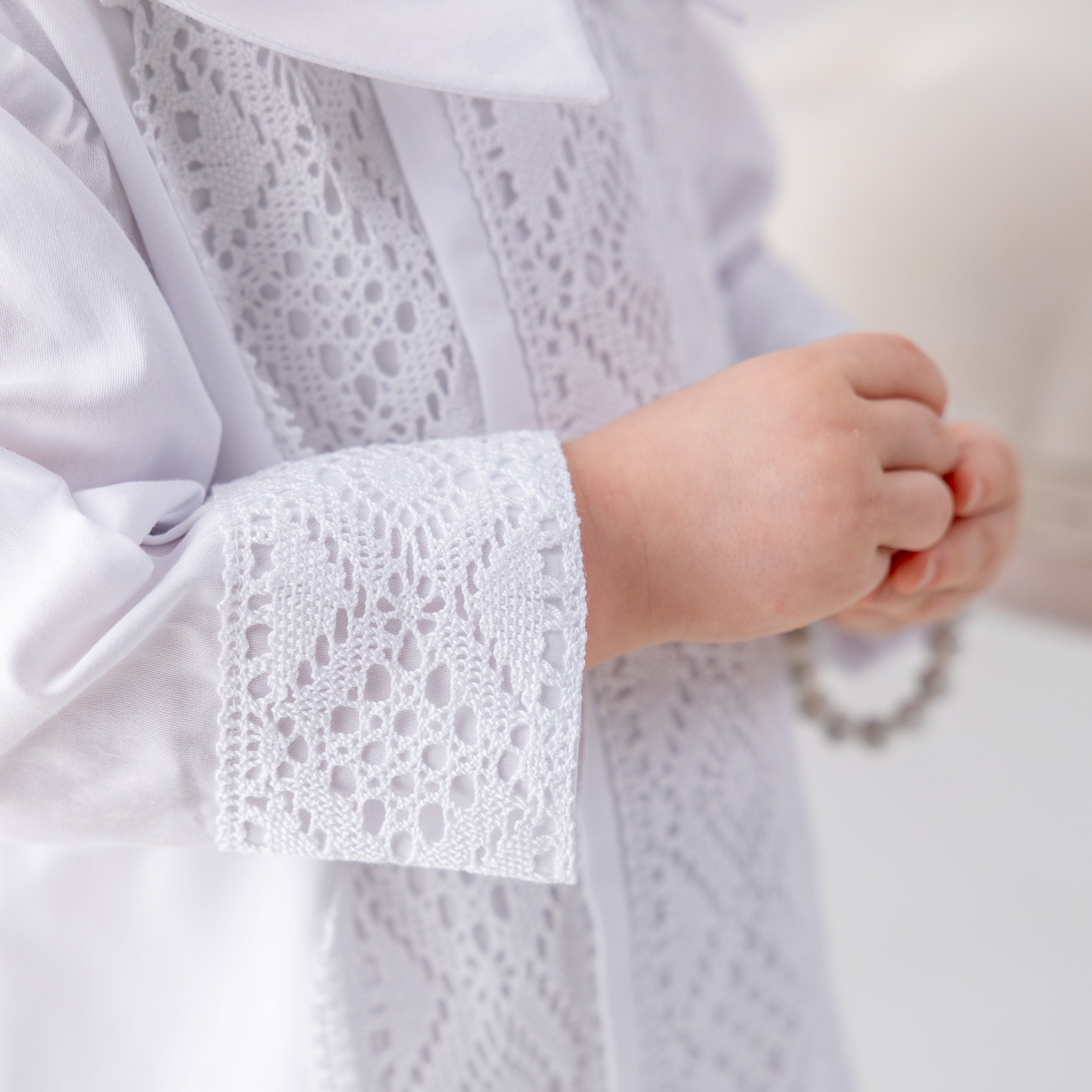 Close-up of a white lace garment with a blurred background