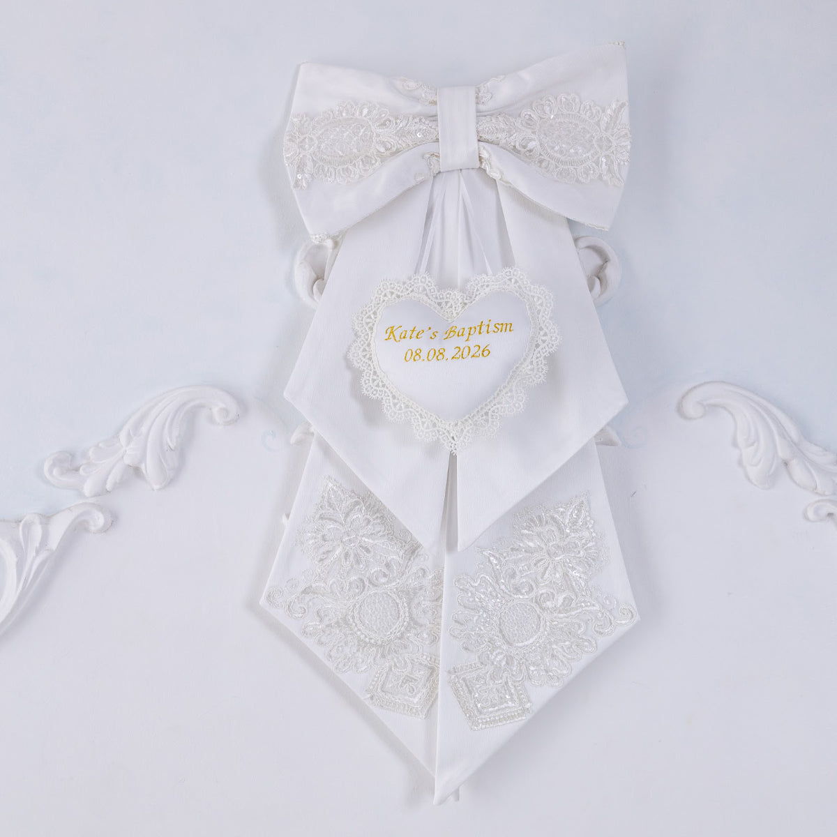 Personalized Baptism Keepsake Bow with decorative elements on a light gray background