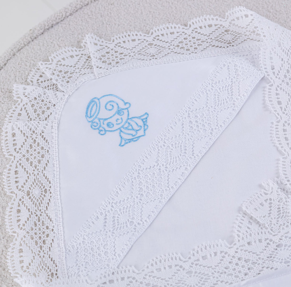 White embroidered baby blanket with a blue angel 
