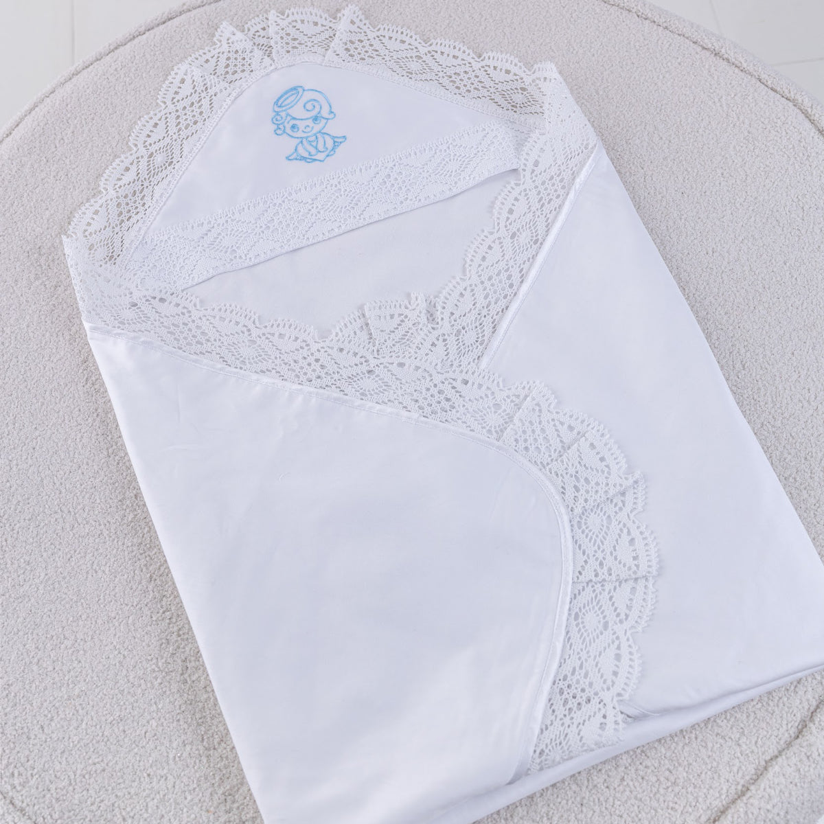 White lace-trimmed baptism balnket with a blue embroidered angel 