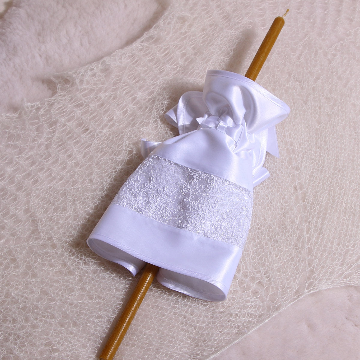 Decorative candle with Fabric Candle Wraps for Baptism on a textured surface