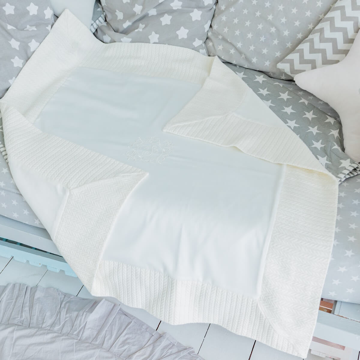 White christening blanket on a bed 