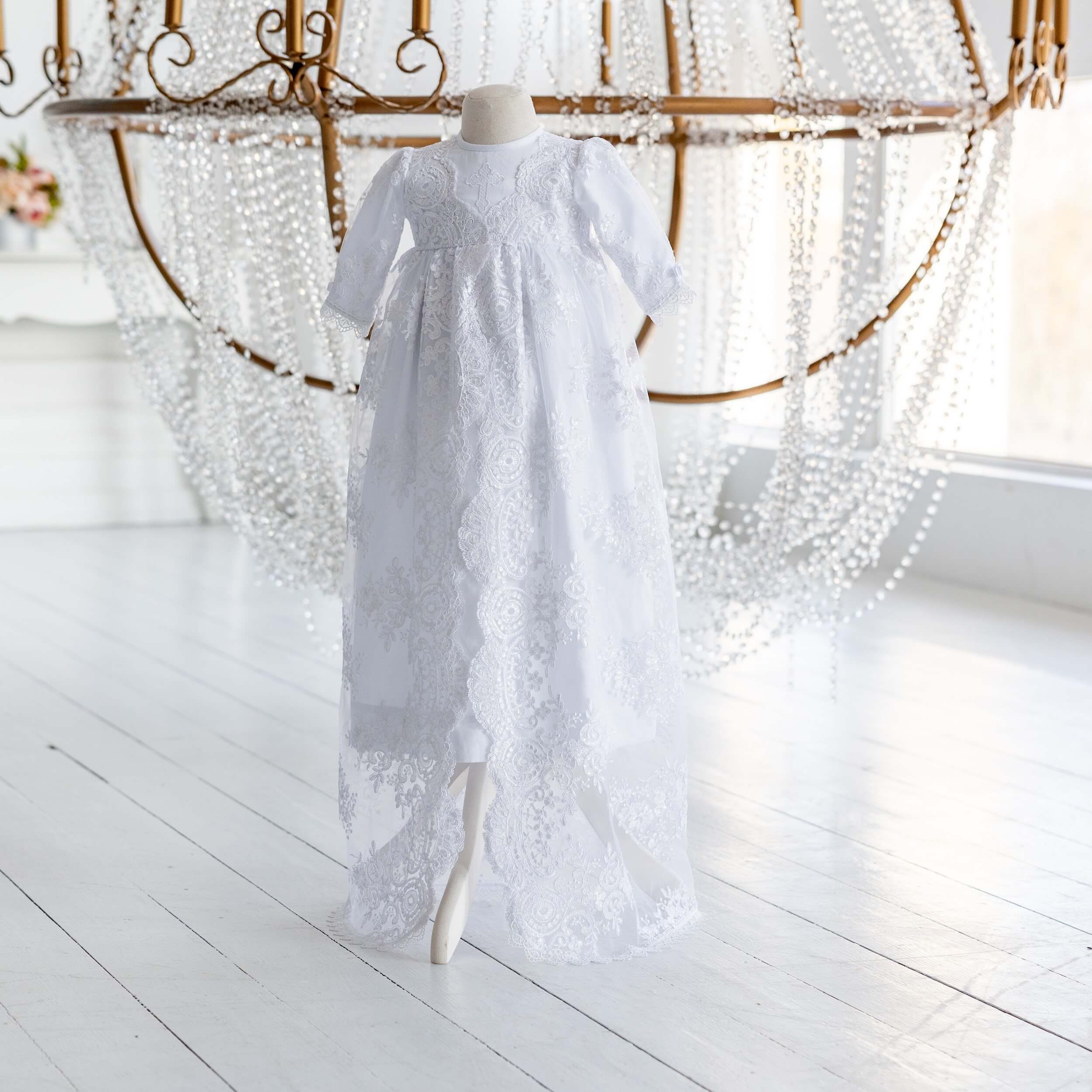 Christening Gown for Girls on a mannequin against a decorative background