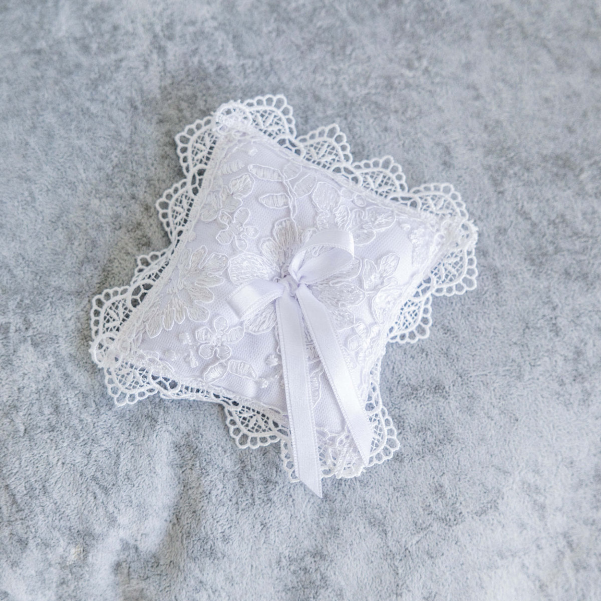 Baptism Cross Pillow on a gray textured background