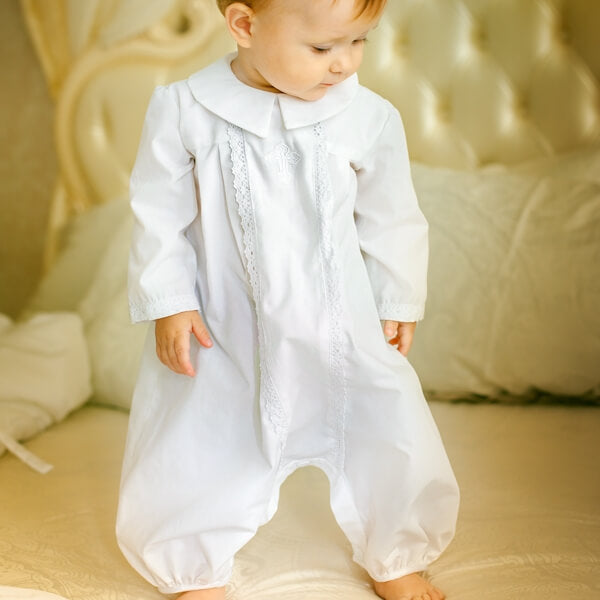Baby in a Christening Outfit for Boys standing on a bed